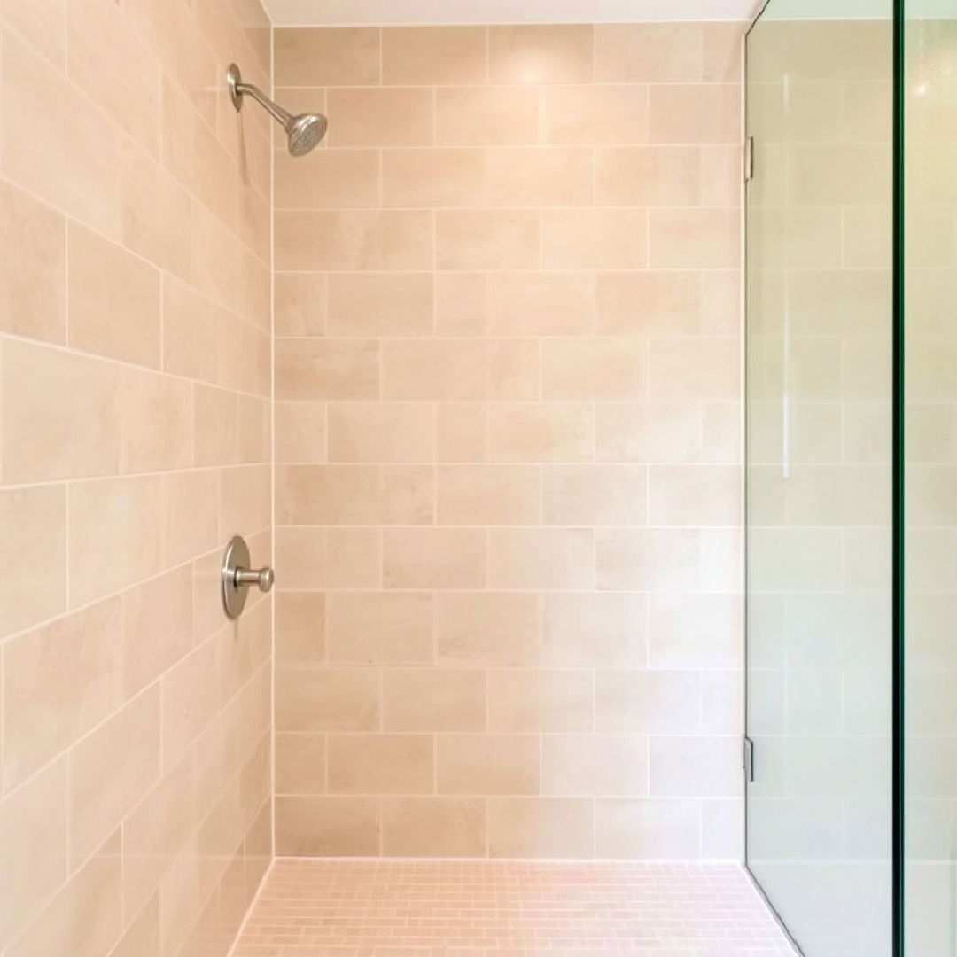 beige shower tiles with white grout